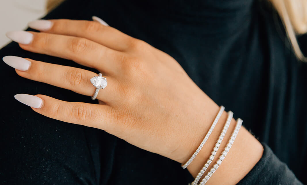 custom pear diamond engagement ring with triple diamond pave band in platinum