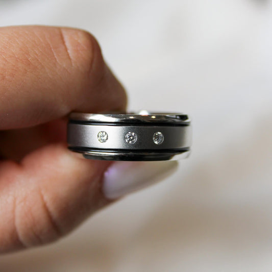 Cobalt chrome mens band with 3 lab grown diamonds and a two black inlays against a white background.