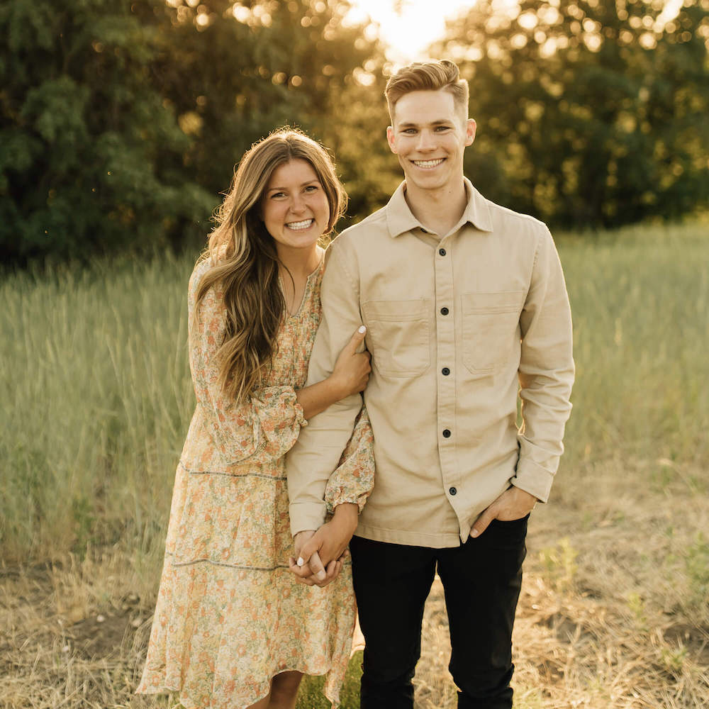 newly engaged couple smiles with their 14k gold custom engagement ring with lab grown diamonds
