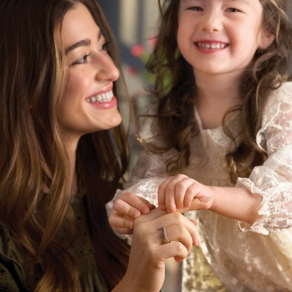a mom and her daughter wearing stackable 14k yellow gold birthstone rings