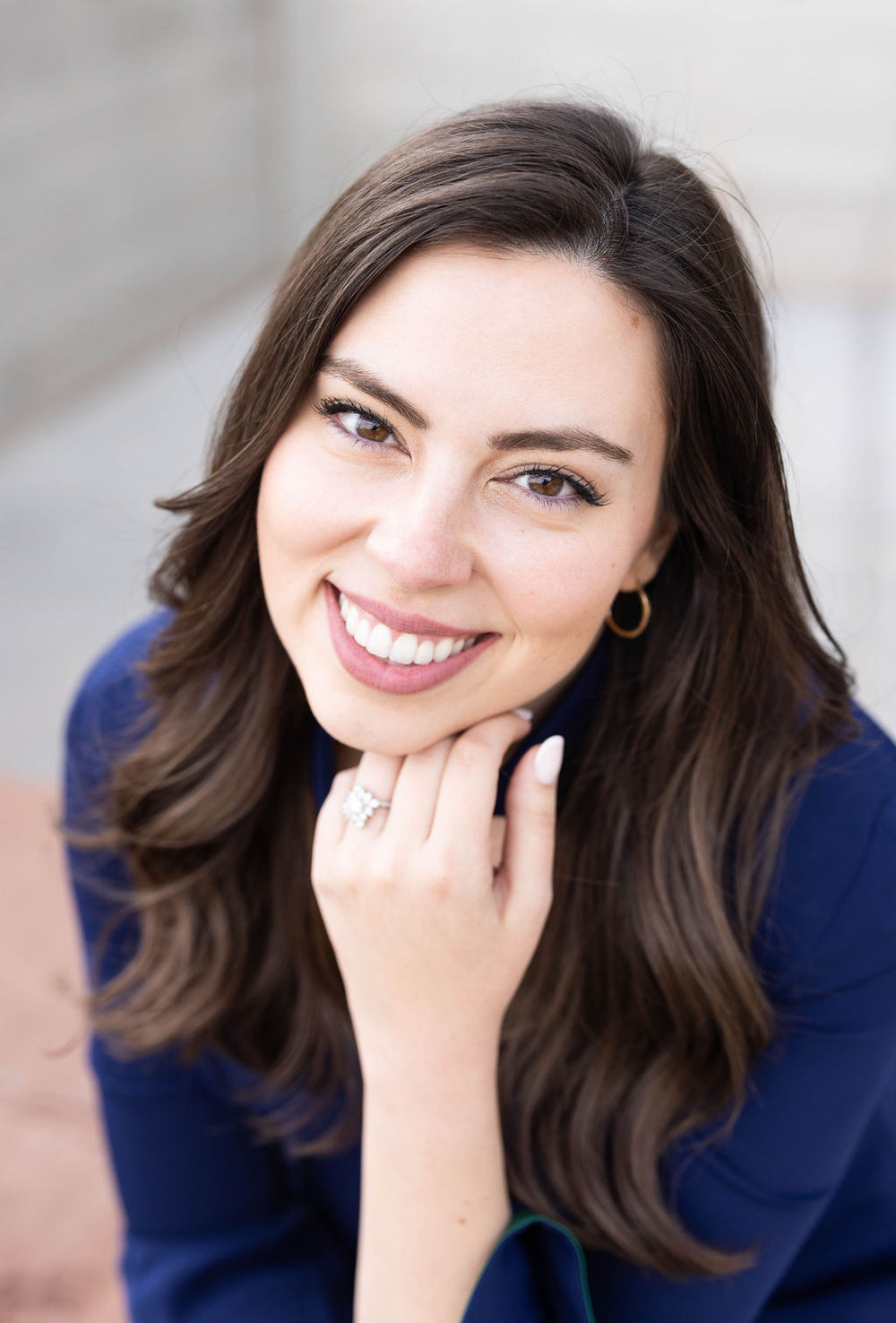 Shannon Baird, your personal jewelry concierge wearing a custom engagement ring and smiling.