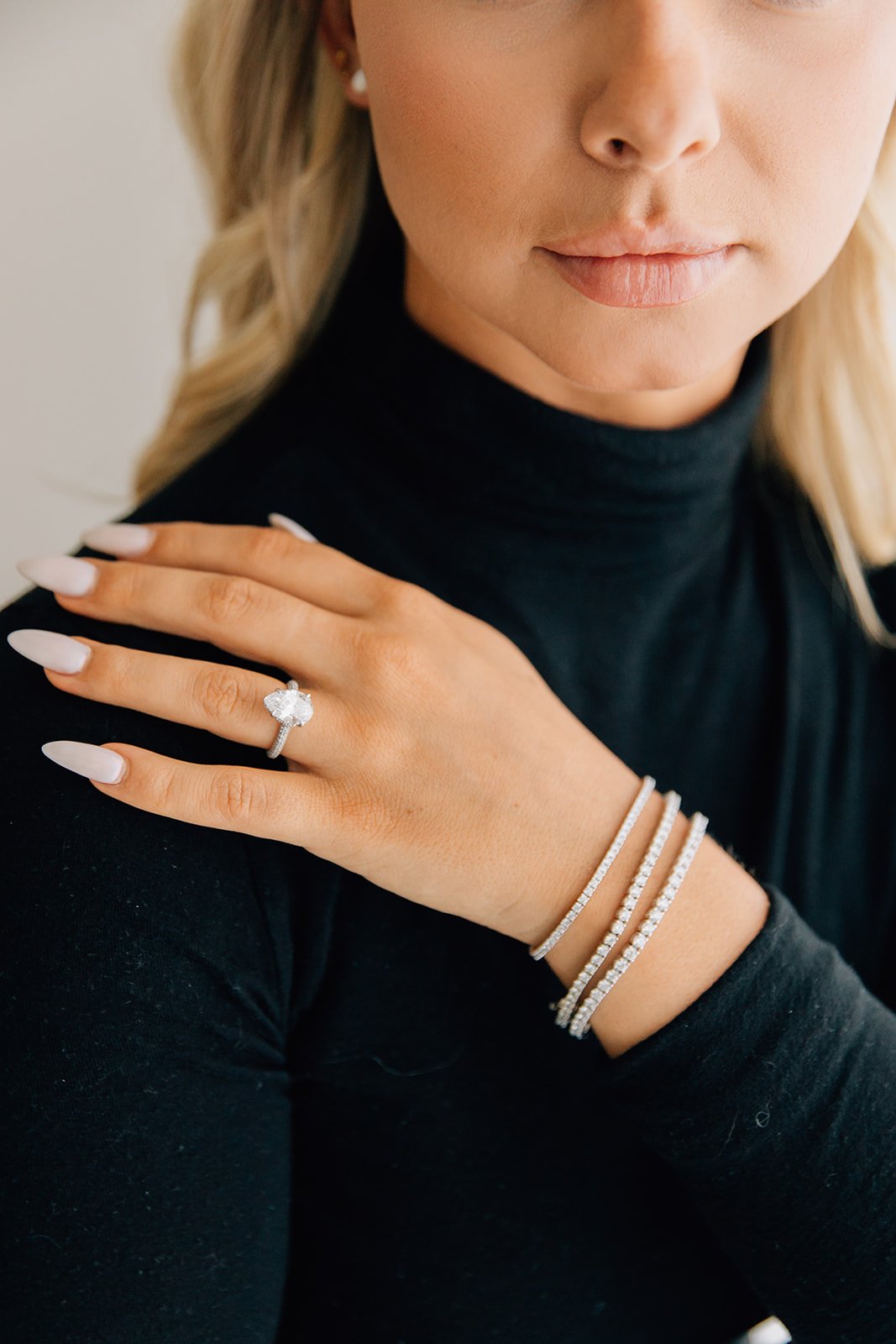 three carat lab grown diamond pear with a hidden halo and triple pave band and three lab grown diamond tennis bracelets
